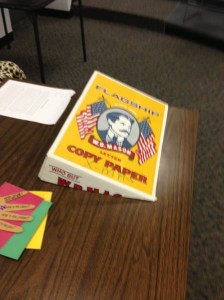 Slant board for student desk made from the top of a box from reams of paper.