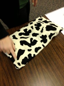 Cushion filled with sand to provide pressure on student's lap while seated  at desk.