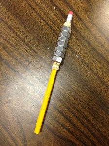 Weighted pencil made with rubber bands and hex nuts